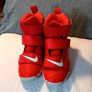 Red Nike high top football cleats